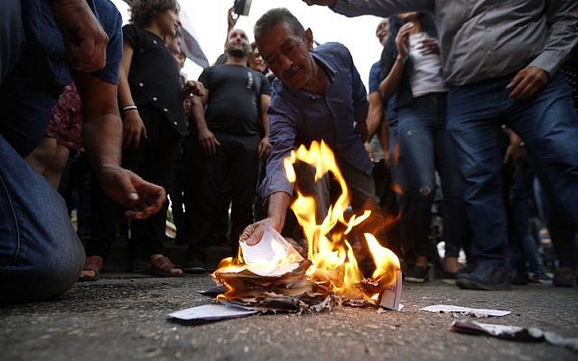 Druze residents of Majdal Shams in the Golan Heights set ablaze makeshift ballot papers during a protest on October 19, 2018. (Jalaa Marey/AFP)