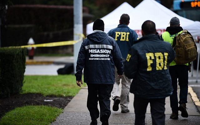 Members of the FBI and others survey the area on October 28, 2018 outside the Tree of Life Synagogue after a shooting there left 11 people dead in the Squirrel Hill neighborhood of Pittsburgh on October 27, 2018. (Photo by Brendan SMIALOWSKI / AFP)