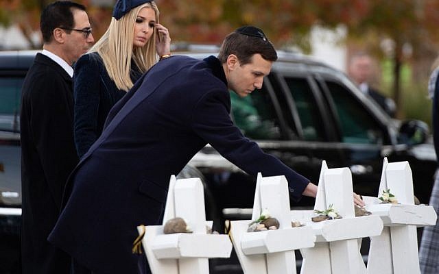 Jared Kusher, alongside Ivanka Trump and Secretary of Treasury Steven Mnuchin, place stones and flowers on a memorial as they pay their respects with US President Donald Trump at the Tree of Life Synagogue following last weekend's shooting in Pittsburgh, Pennsylvania, October 30, 2018. (Photo by SAUL LOEB / AFP)