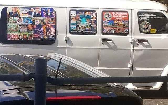 This November 1, 2017, photo shows a van with windows covered with an assortment of stickers in Well, Florida, that apparently was owned by Cesar Sayoc. (Courtesy Lesley Abravanel via AP)