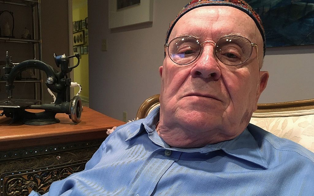 In this October 29, 2018 photo, Holocaust survivor Judah Samet, 80, sits in his living room in Pittsburgh. (AP Photo/Allen G. Breed)