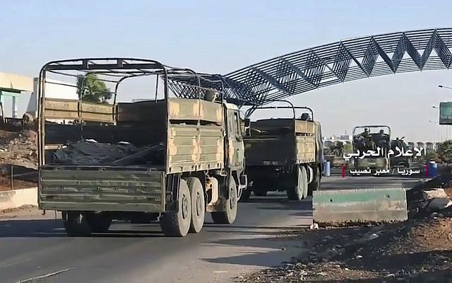 A convoy of Syrian military vehicles at Naseeb border crossing with Jordan, in the southern province of Daraa, Syria, July 7, 2018. (Syrian Central Military Media, via AP/ File)