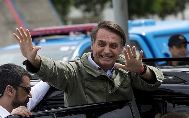 Jair Bolsonaro, then a presidential candidate with the Social Liberal Party, waves after voting in the presidential runoff election in Rio de Janeiro, Brazil, October 28, 2018. (AP Photo/Silvia izquierdo)
