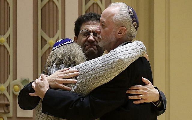 Rabbi Jeffrey Myers, right, of Tree of Life/Or L'Simcha Congregation hugs Rabbi Cheryl Klein, left, of Dor Hadash Congregation and Rabbi Jonathan Perlman during a community gathering held in the aftermath of a deadly shooting at the Tree of Life Synagogue in Pittsburgh, October 28, 2018. (AP Photo/Matt Rourke)