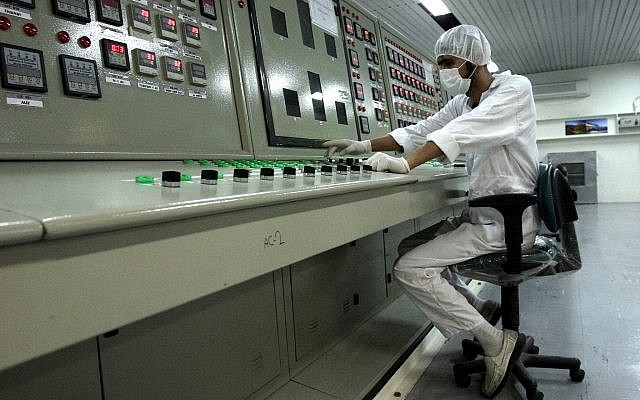In this February 3, 2007, file photo, an Iranian technician works at the Uranium Conversion Facility just outside the city of Isfahan 255 miles (410 kilometers) south of the capital Tehran, Iran. (AP Photo/Vahid Salemi, File)