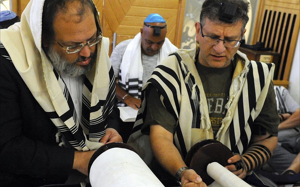Illustrative: Orthodox Jews read the morning Torah portion at the Jewish Community Center in Larnaca, Cyprus. (Larry Luxner/ Times of Israel)