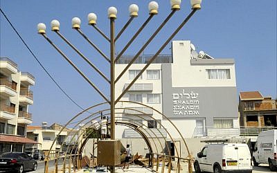 Illustrative: Construction workers build the frame of a World War II-era Quonset hut in front of the Jewish Community Center in Larnaca, Cyprus. (Larry Luxner/Times of Israel)