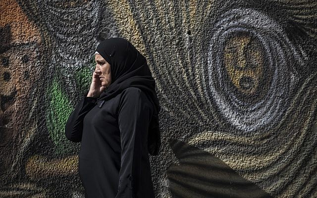 A Palestinian woman speaks on a cell phone in Ramallah on October 28, 2014.  (Hadas Parush/Flash90)