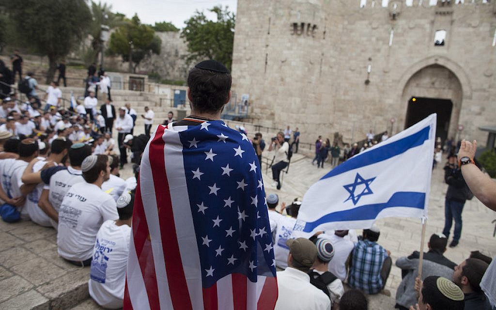 A man wearing an American flag watch the flags march outside Damascus Gate on May 13, 2018 in Jerusalem, Israel. (Lior Mizrahi/Getty Images via JTA)