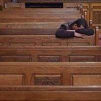 Illustrative: A Coptic Christian man mourns victims killed in an attack a day earlier, during an early morning ceremony at the Prince Tadros church in Egypt's southern Minya province, on November 3, 2018. (MOHAMED EL-SHAHED / AFP)
