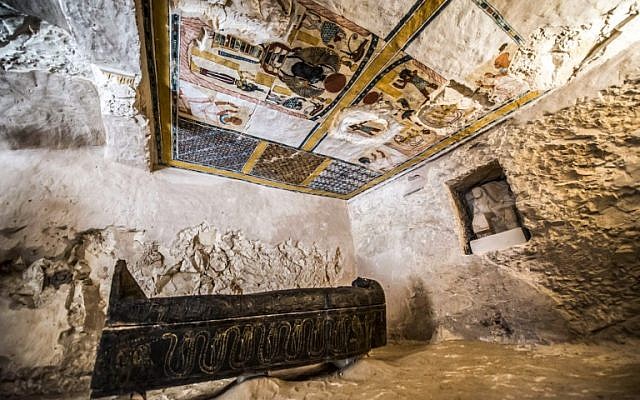 This picture taken on November 24, 2018 shows a carved black wooden sarcophagus inlaid with gilded sheets, dating to Egypt's Late period (7th-4th century BC), lying in a burial chamber decorated with colored scenes depicting the owner with members of his family, discovered by an Egyptian archaelogical mission at the site of Tomb TT28 at Al-Assasif  necropolis on the west bank of the Nile north of the southern Egyptian city of Luxor. (Khaled DESOUKI / AFP)