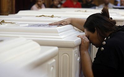 A relative of a slain Christian grieves during funeral service at Church of Great Martyr Prince Tadros, in Minya, Egypt on Nov. 3, 2018. (AP Photo/Amr Nabil)