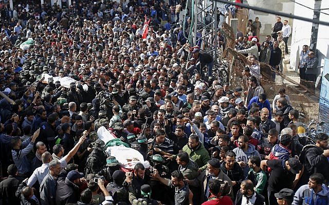 Palestinian mourners carry the bodies of two of the seven Hamas jihadists who were killed in an Israeli raid, during their funerals in Khan Younis, southern Gaza Strip, November 12, 2018. (AP Photo/Adel Hana)