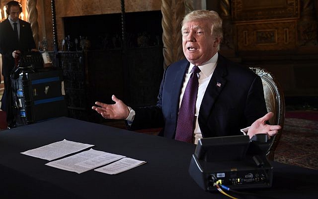 US President Donald Trump speaks to reporters following his teleconference with troops from his Mar-a-Lago estate in Palm Beach, Florida, November 22, 2018. (AP Photo/Susan Walsh)
