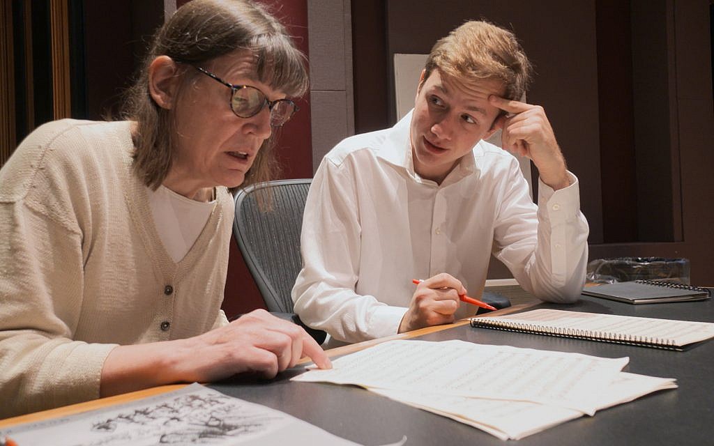 This Nov. 7, 2018, photo provided by the University of Michigan shows Professor Patricia Hall and graduate student Joshua Devries reviewing the music manuscript for "The Most Beautiful Time of Life" at the Duderstadt Center recording studio on campus in Ann Arbor, Michigan (Christopher Boyes/University of Michigan via AP)