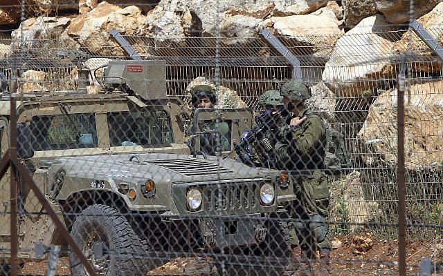 Israeli soldiers patrols near the area where Hezbollah held a rally to mark al-Quds (Jerusalem) Day, at the village of Maroun el-Rass on the Lebanon-Israel border, June 8, 2018. (AP/Mohammed Zaatari, File)