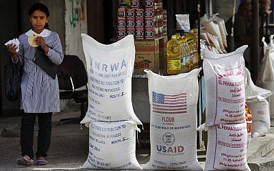 A Palestinian pupil walks past United Nations Relief and Works Agency, (UNRWA) and USAID humanitarian aid, on June 6, 2010 in the Shatie refugee camp in Gaza City. (AP Photo/Lefteris Pitarakis, File)