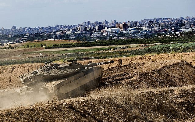 File: An Israeli tank takes a position at the Gaza Strip border, October 27, 2018.  (AP/Tsafrir Abayov)