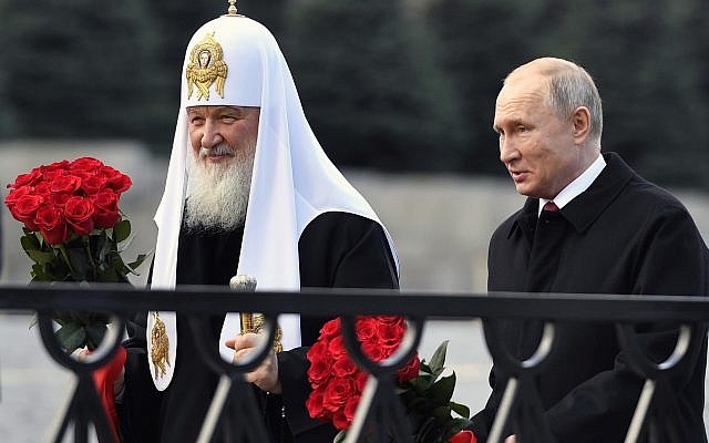 Russian President Vladimir Putin and Russian Orthodox Church Patriarch Kirill, left, walk to lay flowers at the monument of Minin and Pozharsky at Red Square in Moscow, during National Unity Day in Moscow, Russia, November 4, 2018. (Alexander Nemenov/Pool/AP)