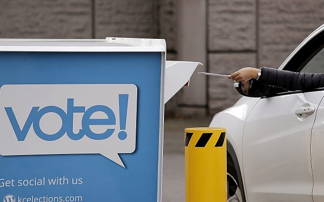 A driver drops a ballot into a drop box at the King County Elections office, November 5, 2018, in Renton, Wash. (Elaine Thompson/AP)