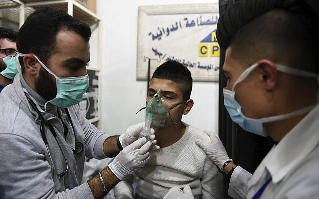 A man receiving oxygen through respirators following a suspected chemical attack on the town of al-Khalidiya, in Aleppo, Syria, November 24, 2018 (SANA via AP)