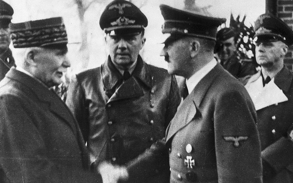 German Chancellor Adolf Hitler, right, shaking hands with Head of State of Vichy France Marshall Philippe Petain, in occupied France, October 24, 1940. (AP Photo)