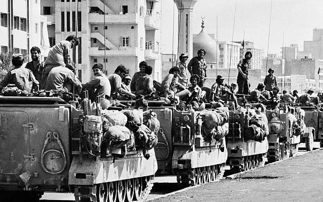 Israeli armored personnel carriers are positioned near a mosque on the outskirts of the Lebanese capital of Beirut, Wednesday June 16, 1982. (AP Photo/Rina Castelnuovo)
