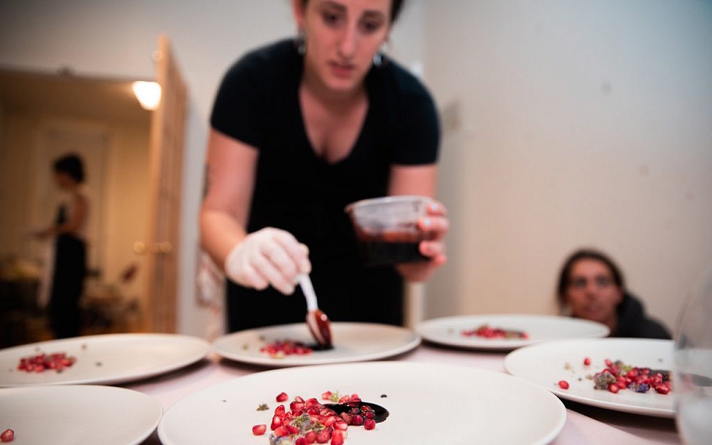 Adina Halpern plates a leg of lamb in pomegranate sauce. (Hanoch Melamed Cohen)