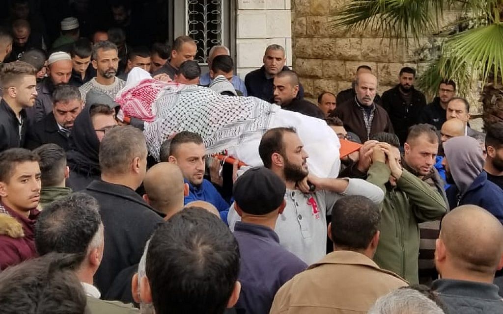 Family members carry Mahmoud Abu Asabeh's body to a burial site in Halhoul on November 14, 2018. (Adam Rasgon/ Times of Israel)