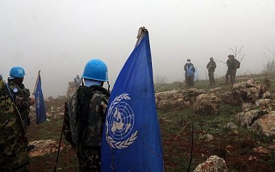 A picture taken from the southern Lebanese village of Meiss al-Jabal on December 9, 2018, shows Israeli and United Nations Interim Forces in Lebanon (UNIFIL) soldiers gathered on the Israeli side of the border between the two countries (Ali DIA / AFP)