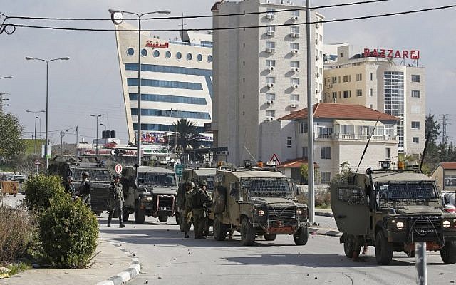 Israeli soldiers deploy during clashes in the West Bank city of Ramallah following a raid on December 10, 2018, one day after a drive-by shooting attack next to a settlement in which many Israelis were injured. (ABBAS MOMANI / AFP)