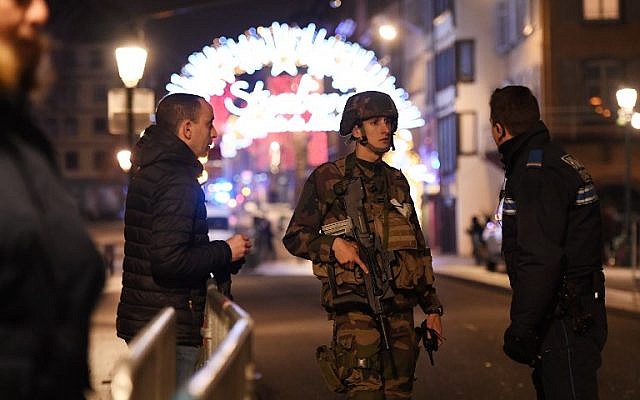Policemen speak with a military in the streets of Strasbourg, eastern France, after a shooting breakout, on December 11, 2018. (Frederick FLORIN / AFP