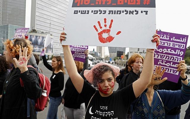 File: Women take part in a rally against domestic violence in Tel Aviv on December 12, 2018. (Jack Guez/AFP)
