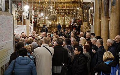 A group of tourists and pilgrims visit the Church of the Nativity, the place where Jesus is said to have been born, in the biblical West Bank town of Bethlehem, on December 12, 2018. (THOMAS COEX / AFP)