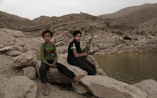 In this July 30, 2018, photo, a 17 year-old boy holds his weapon in High dam in Marib, Yemen (AP Photo/Nariman El-Mofty)