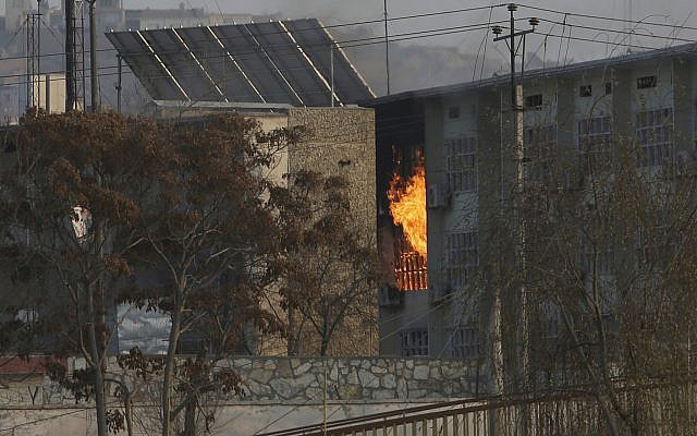 Flames rise from a government building after an explosion and attack by gunmen, in Kabul, Afghanistan, December 24, 2018. (AP Photo/Rahmat Gul)
