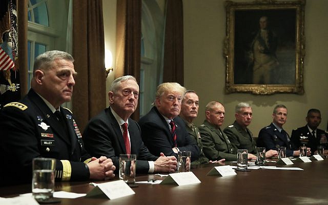 US President Donald Trump with, from left, Chief of Staff of the Army Gen. Mark Milley, Defense Secretary Jim Mattis, Chairman of the Joint Chiefs of Staff Gen. Joseph Dunford and Marine Corps Commandant Gen. Robert Neller, listen to questions from members of the media during a briefing with senior military leaders in the Cabinet Room at the White House on October 23, 2018. (AP Photo/Manuel Balce Ceneta)