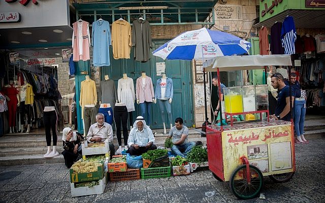 Palestinians shop at a vegetable market in the West Bank city of Bethlehem, August 30, 2018 (Miriam Alster/FLASH90)