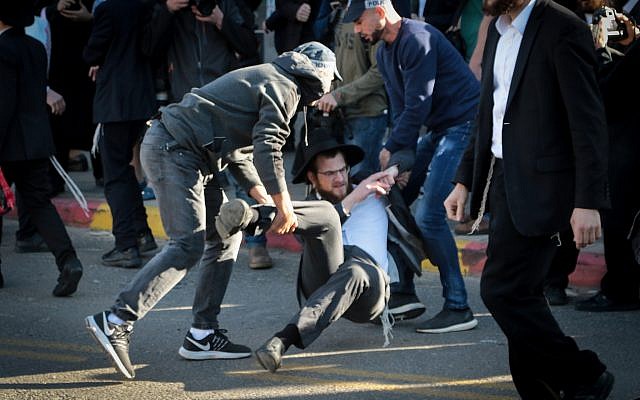 Ultra-Orthodox Israelis clash with police during an anti-draft protest in Bnei Brak, December 10, 2018 (Roy Alima/Flash90)