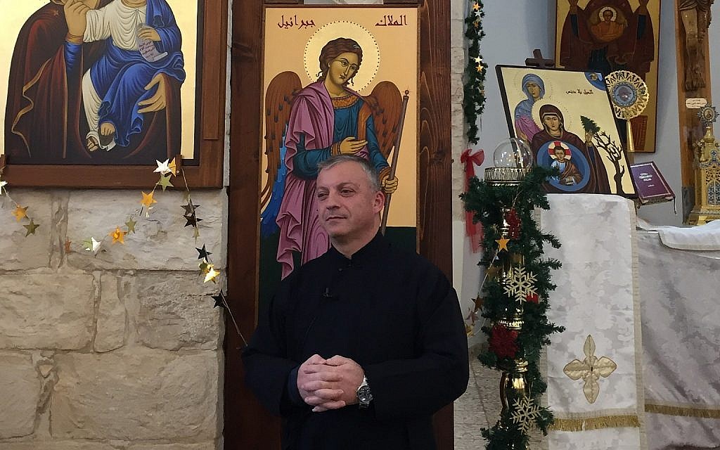 Father Michael Assi, in the Mar Elias church in Fassuta. (Federico Maccioni/ Times of Israel)