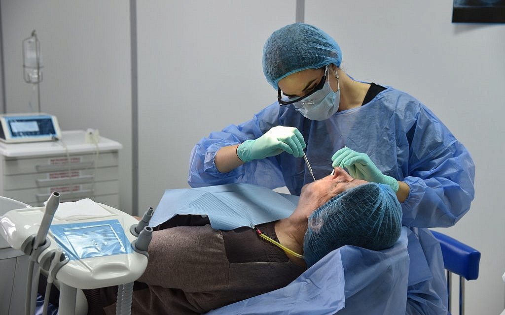 Giulia Gal Addadi treats a patient in a dental lab at Nicolae Testemitanu Medical University in Moldova. (Andrei Ichim/ Nicolae Testemitanu Medical University)