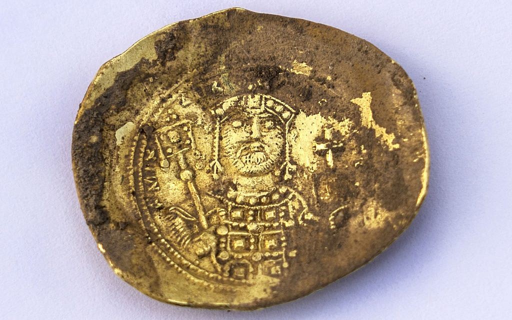 Convex-shaped gold 'nomisma histamenon' coin minted by the Byzantine emperor Michael VII Doukas (1071 – 1079 CE) that was recently unearthed at the Caesarea Maritima archaeological site. (Yaniv Berman, courtesy of the Caesarea Development Corporation)