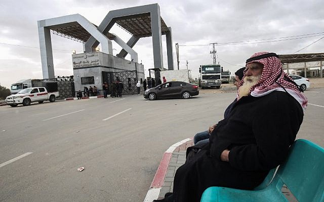 In this file photo taken on January 8, 2019, Palestinians sit waiting at the Rafah border crossing with Egypt, in the southern Gaza Strip. (SAID KHATIB / AFP)