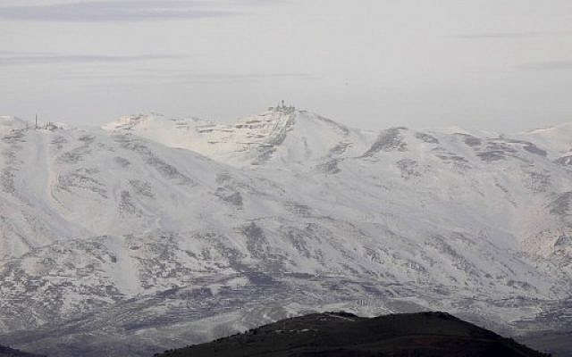 A picture taken from the Israeli side of the Golan Heights shows snow covered mountain inside Syria on January 20, 2019. (Jalaa Marey/AFP)