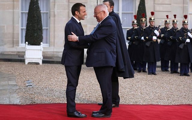 President Reuven Rivlin, right, is welcomed by French president Emmanuel Macron upon his arrival at the Elysee Palace in Paris on January 23, 2019. (Ludovic MARIN/AFP)