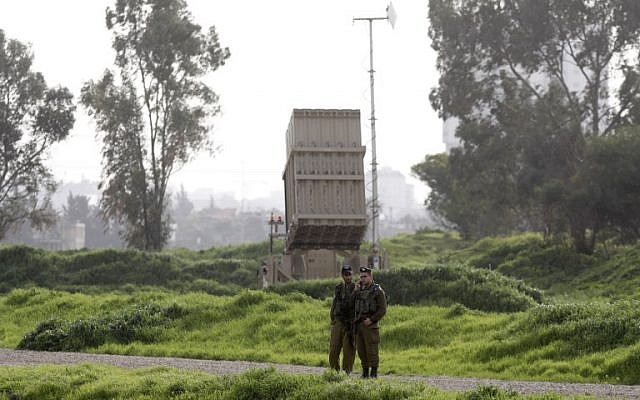 Israeli soldiers stand near a battery of the Iron Dome missile defense system deployed in Tel Aviv on January 24, 2019. (Menahem Kahana/AFP)