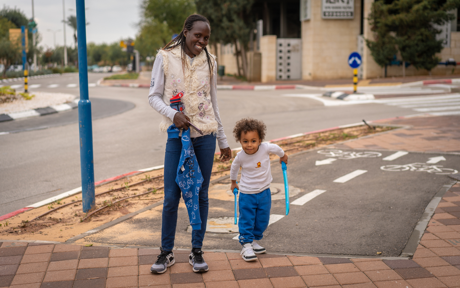 Lonah Chemtai Salpeter with her son, Roy, outside their home in Shoham, central Israel, December 9, 2018. (Luke Tress/Times of Israel)