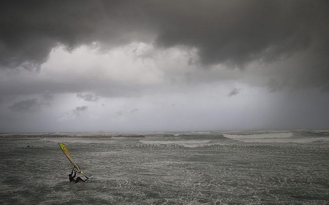 Wind surfers ride on waves in the Mediterranean Sea in Tel Aviv on January 16, 2019. (AP Photo/Oded Balilty)
