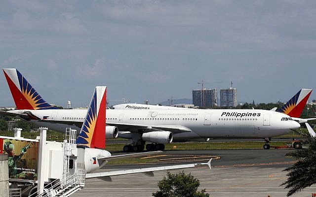 Philippine Airlines passenger planes are parked at the carrier's terminal at the Manila International Airport on April 12, 2012, in Pasay city, south of Manila, Philippines. (AP Photo/Bullit Marquez)