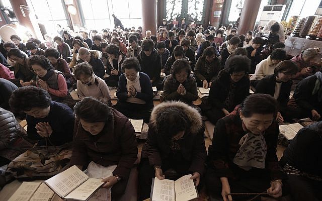 Parents pray for their children’s success in the Scholastic Aptitude Test at the Jogye Temple in Seoul, South Korea, Nov. 15, 2017 (AP Photo/Ahn Young-joon)